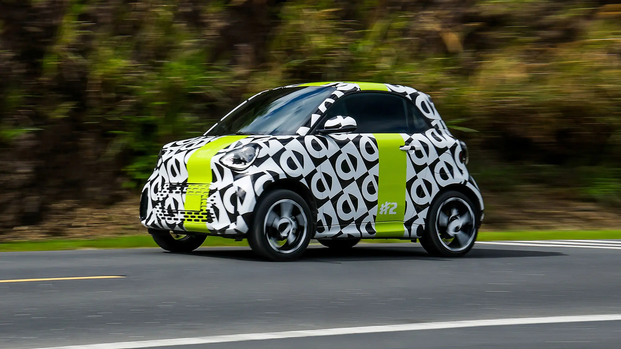 Smart #2 prototype (2026): front three-quarter driving, camouflage wrap